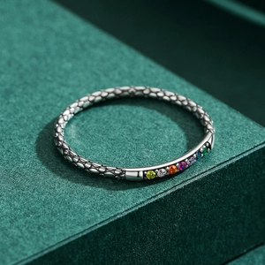 Vintage silver ring featuring snake skin texture and seven colorful rainbow gemstones