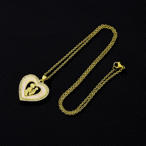 Detailed close-up of heart pendant with mother-child relief and white shell inlay