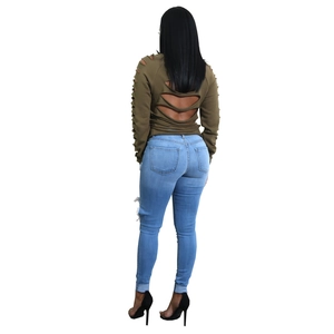 Set donna top verde oliva con tagli e jeans aderenti in denim blu strappato vista posteriore