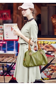 Green PU leather tote bag with brown straps and gold hardware styled on a fashion model