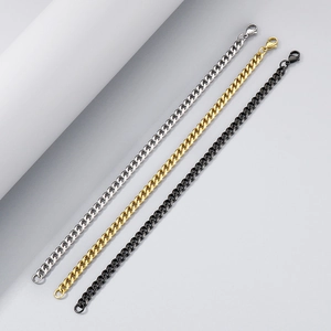 Detailed view of silver, gold, and black cuban chain set with secure lobster clasps