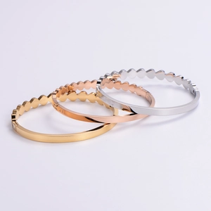 Minimalist stainless steel heart bracelets in gold, rose gold, and silver finishes