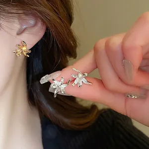 Minimalist metallic flower stud earrings with irregular bionic texture in gold and silver