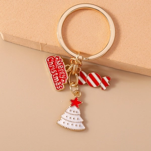 Detailed view of metal Christmas keychain with candy cane and tree charms