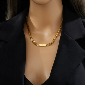 Vintage gold chunky link necklace with a rectangular diamond pendant on a professional model