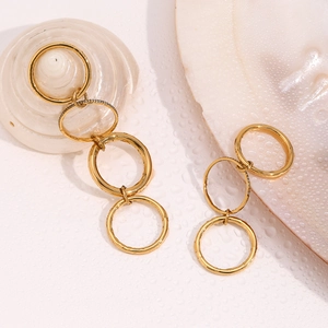 Detail of 18K gold-plated multi-layer link earrings with sparkling pavé zircons on water drops