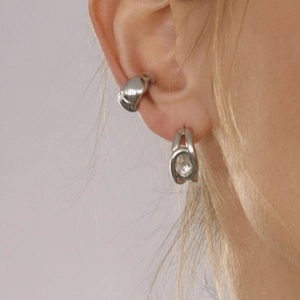 Silver C-shape stainless steel earrings with clear zircon stones on female model