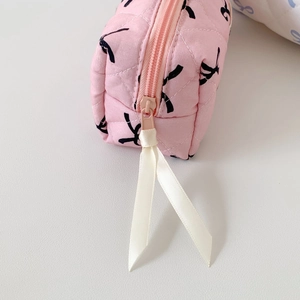 Pink quilted bow pencil case and makeup bag with zip closure and ribbon detail