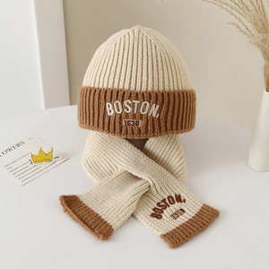 Detail of winter knit hat and scarf set with Boston embroidery in cream and brown