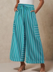 Detail of colorful striped wide leg pants featuring drawstring waist and cargo pockets