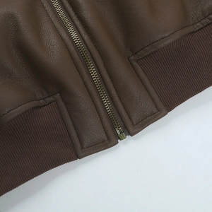Detailed macro view of high-quality brown PU leather texture and premium metal zipper