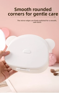 Detail of white bear-shaped portable makeup mirror showing smooth edges and mini size