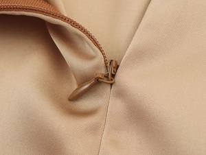Detailed close-up showing the seamless invisible zipper on brown sequin skirt fabric
