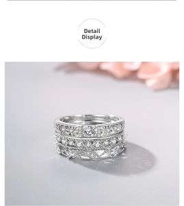 Macro shot of stacked 925 silver rings with round cubic zirconia and hollow star patterns