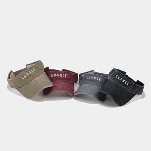 Close-up of letter embroidery and washed cotton fabric on sun visor hats in four colors