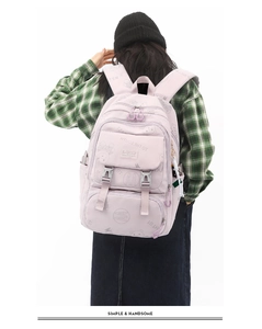 Rear view of a light pink school backpack with cute bear patterns and multiple pockets