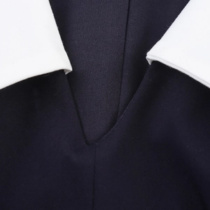 Preppy style sleeveless mini dress featuring a contrast white lapel collar and V-neckline