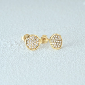 Detailed macro view of S925 sterling silver stamp on gold flower stud earrings