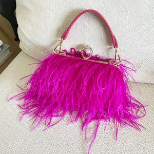 Close-up of rose red ostrich feather evening bag with crystal encrusted gold clasp
