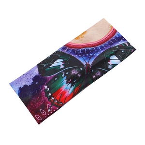 Detail of cross-knot yoga headband featuring vibrant purple and red butterfly patterns