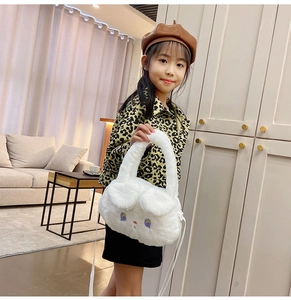 Toddler girl wearing white plush bunny handbag with leopard print jacket and beret