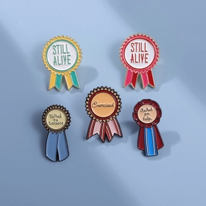 Close-up of five colorful enamel ribbon medals with motivational achievement phrases