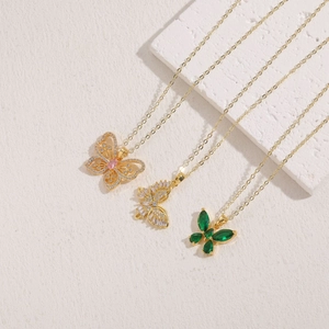 Detail view of butterfly pendants with colorful zircon gemstones and gold-plated chains
