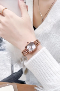 Elegant rose gold square watch for women with metal bead bracelet on a model wrist