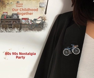 Close-up of a blue vintage bicycle brooch with sparkling rhinestones on a black blazer lapel