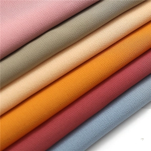 Close-up of multicolored chiffon fabric swatches showing fine grain texture and soft drape