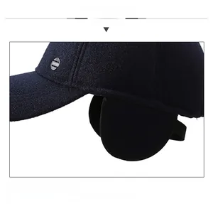 Close-up of thick winter baseball cap with ear flaps and metallic Sport emblem
