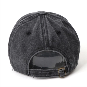 Detail of adjustable metal buckle and vintage washed denim texture on baseball cap