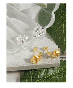 Detail of S925 sterling silver wavy stud earrings in gold and silver finishes