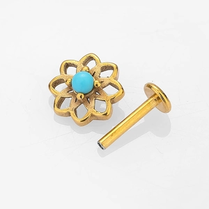 Golden stainless steel labret stud featuring a hollow flower design with turquoise stone