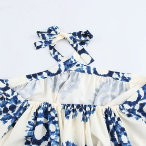 Halter neck maxi dress with blue and white geometric tie-dye print and bow detail