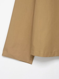 Detailed close-up of khaki short jacket fabric showing fine woven texture and stitching