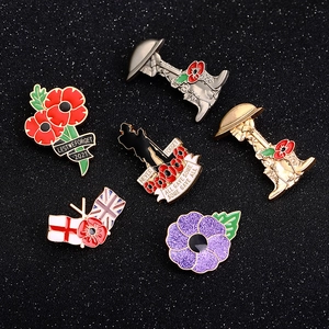 Detail of 6 Remembrance poppy brooches with rhinestones and enamel on black background