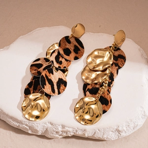 Golden irregular metal earrings with leopard print and textured fabric in a retro style