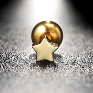 Detailed macro view of a gold star zircon earring with a stainless steel screw ball back