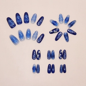 Detailed flat lay of blue 3D butterfly and star pattern press-on nails set