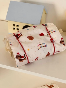 Detail of Christmas themed travel pouch with sausage dog print and red elastic closure