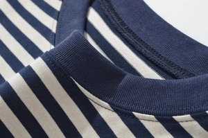 Detail of navy and beige striped crew neck T-shirt showing collar stitching and fabric texture