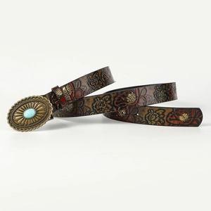 Detail of brown leather belt with red floral embossing and turquoise brass buckle