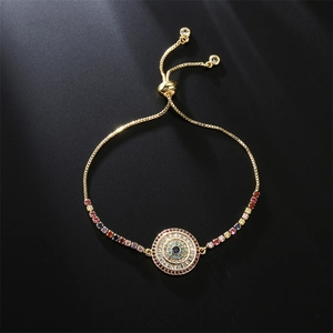 Macro shot of evil eye bracelet featuring rainbow cubic zirconia and gold box chain details