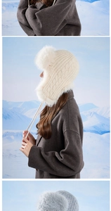 Close-up of thick cable knit winter earflap hat with fluffy faux fur trim and tassels