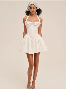Full view of white halter dress with blue floral embroidery and matching headscarf