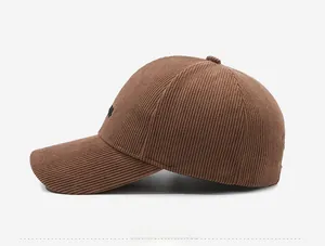 Side view of brown corduroy baseball cap showing fine texture and letter embroidery
