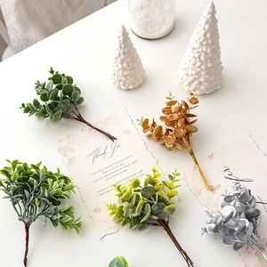 Faux eucalyptus pine branches in green, gold, and silver for Christmas DIY floral decor