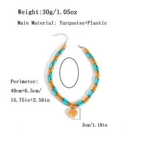 Double-layered turquoise bead necklace with a heart pendant and golden accents on white background