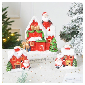 Detailed view of red ceramic Christmas village ornaments with snow and Santa figurines